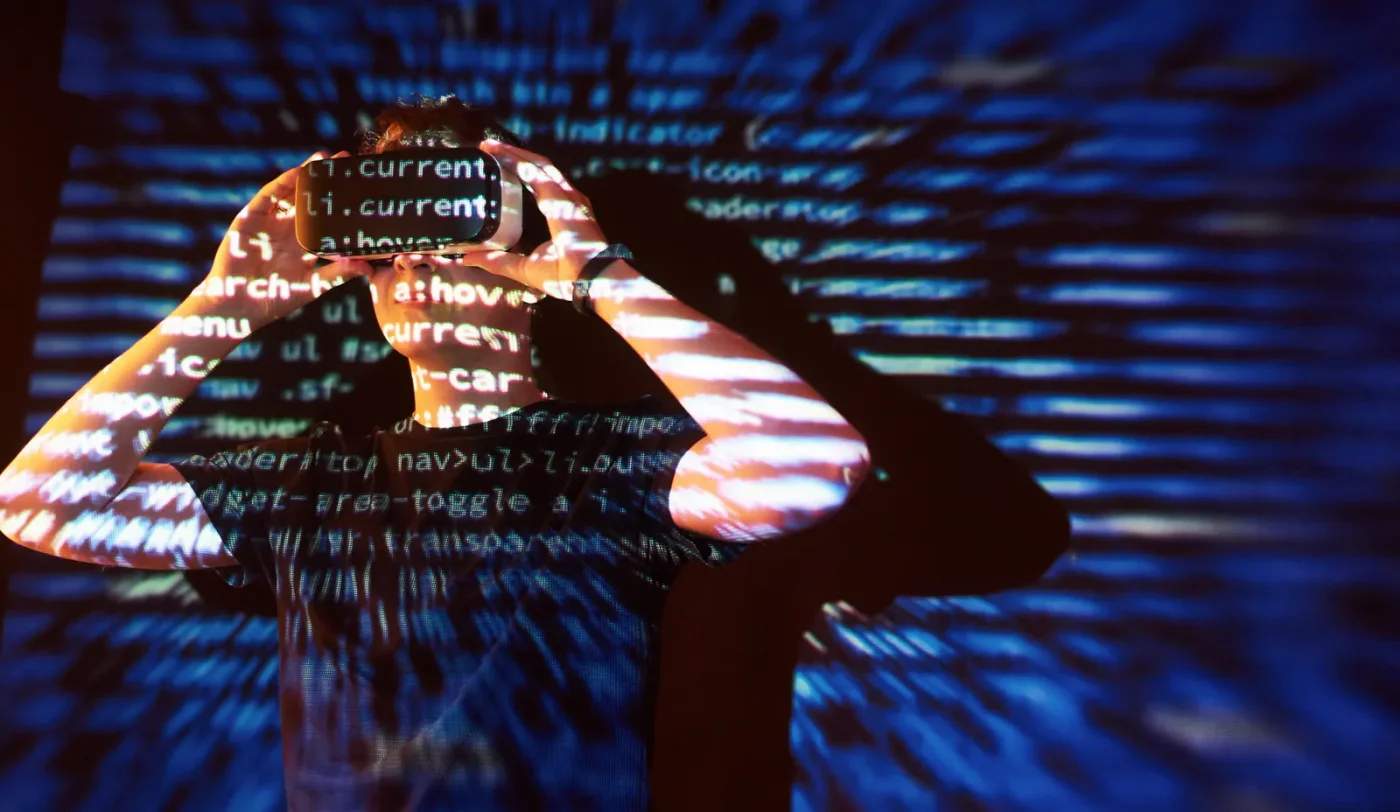 double-exposure-caucasian-man-virtual-reality-vr-headset-is-presumably-gamer-hacker-cracking-code-into-secure-network-server-with-lines-code-10139135.webp