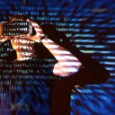 double-exposure-caucasian-man-virtual-reality-vr-headset-is-presumably-gamer-hacker-cracking-code-into-secure-network-server-with-lines-code-10139135.webp