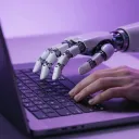 magnific__a-robot-hand-and-a-human-hand-typing-on-one-laptop__31890.webp