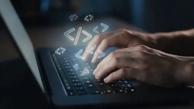 magnific__hands-typing-on-a-laptop-with-glowing-anglebracket__16721.webp